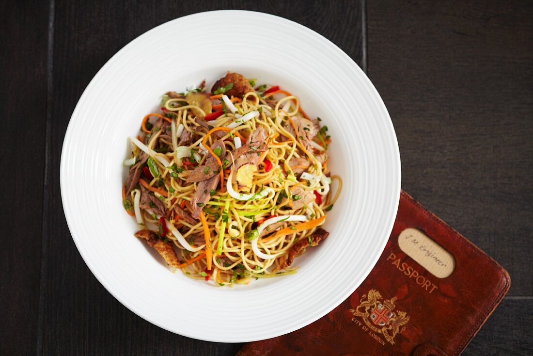 Oriental egg noodles with carrots, spring onions and duck