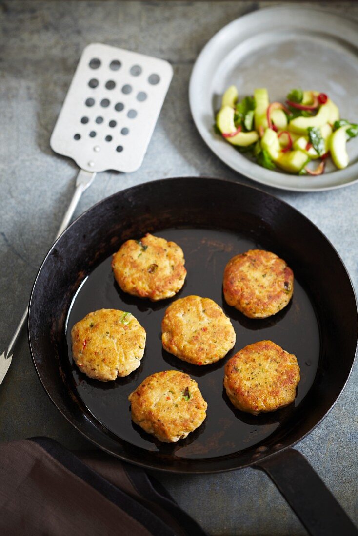 Fish cakes with an avocado and onion salad