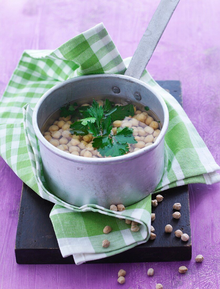 Chickpeas with parsley in a pan of water