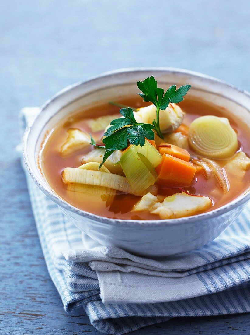 Clear fish soup with leek and carrots