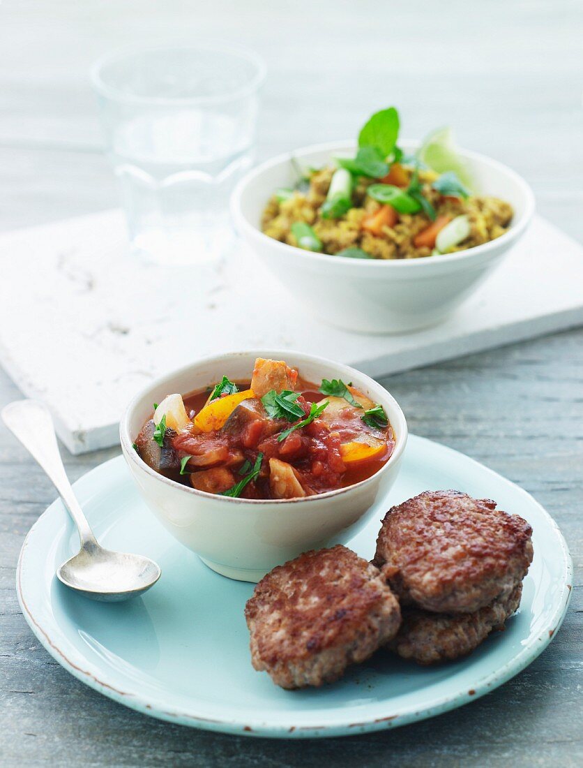 Meatballs with tomato salsa and a rice salad with spring onions