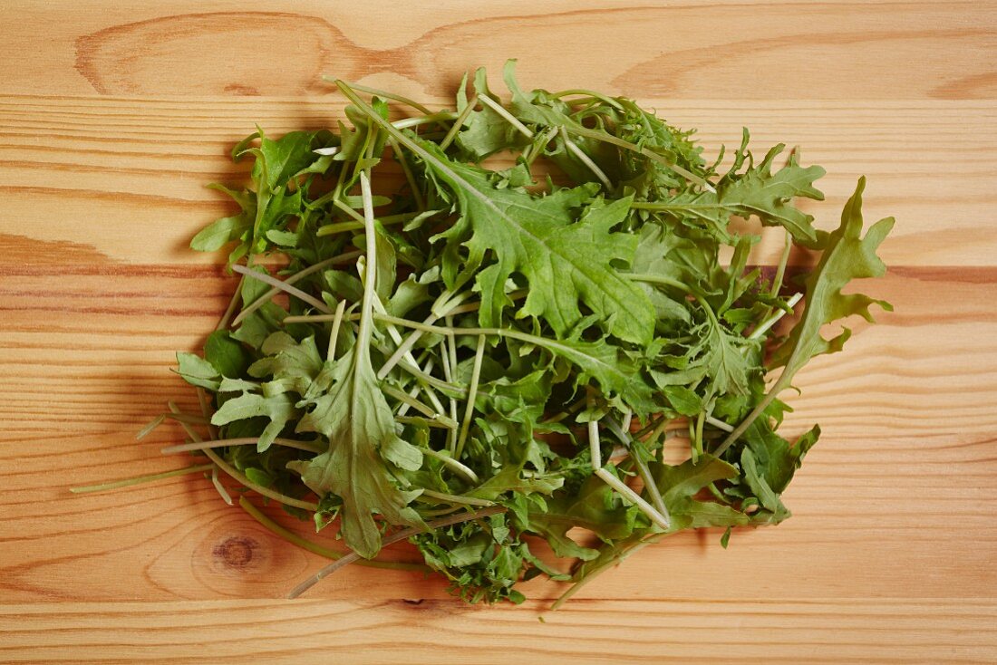 Fresh rocket leaves on a wooden surface