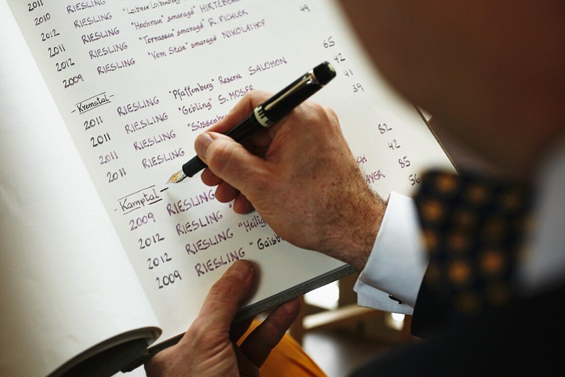 A sommelier writing a wine list