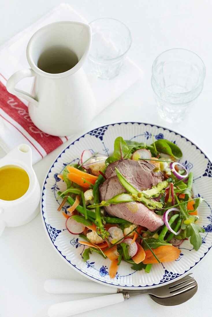 Carrot and bean salad with radishes, rocket and beef