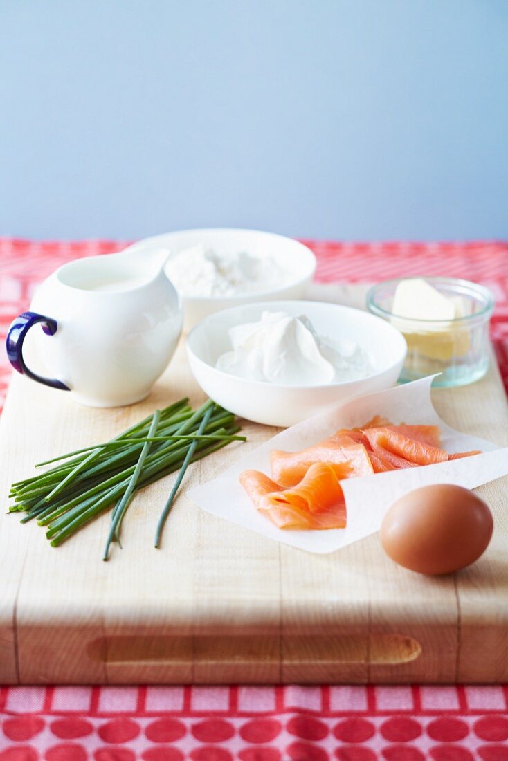 Ingredients for breakfast pancakes (flour, cream cheese, butter, milk, egg, smoked salmon and chives)