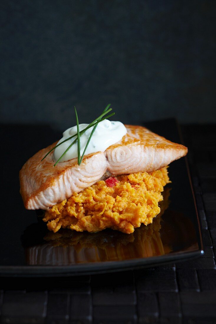 Salmon on sweet potato mash topped with sour cream and chives