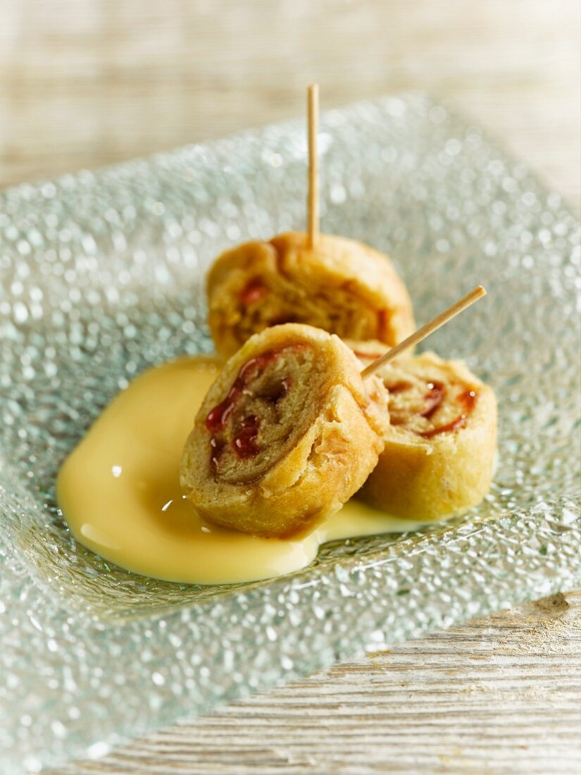 A strawberry jam roly-poly with custard