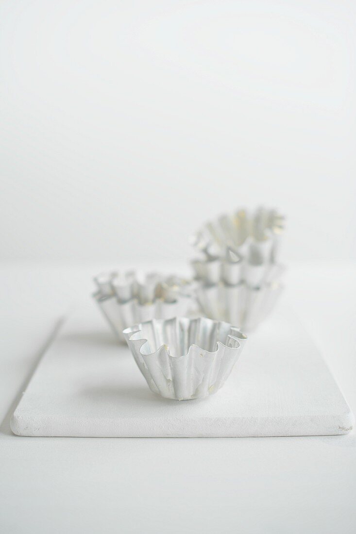 Brioche tins on a white chopping board