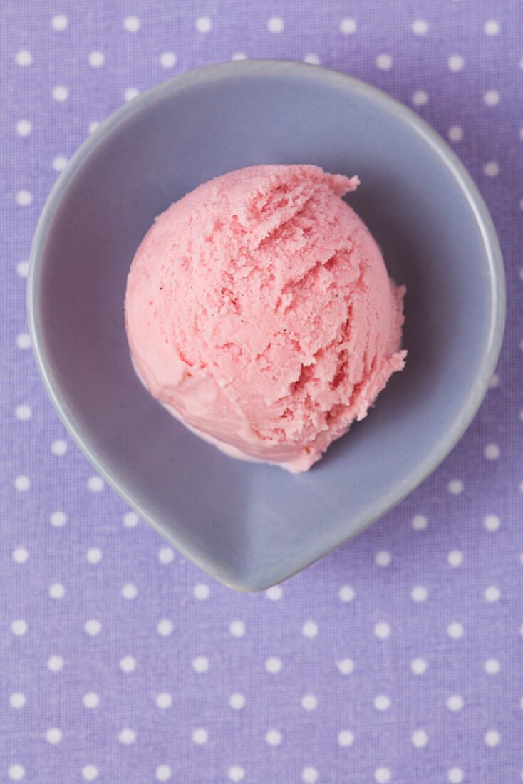 A scoop of homemade raspberry ice cream seen from above