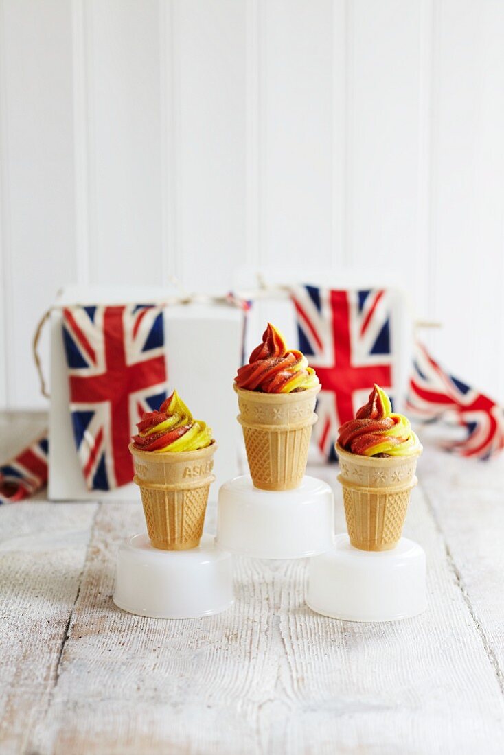 Red and yellow soft-serve ice cream in cones