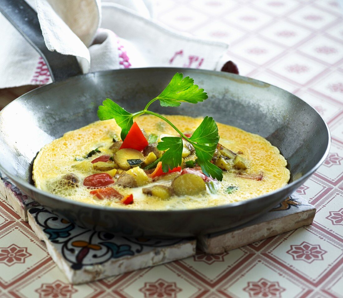 Vegetable omelette in frying pan