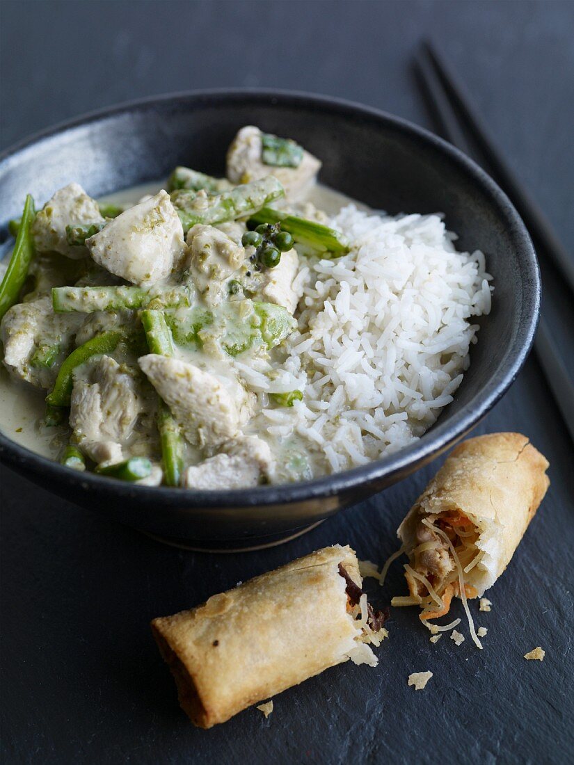 Green Thai chicken curry served with a vegetable spring roll