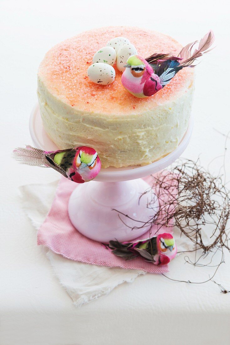 An Easter cake decorated with a bird and sugar eggs