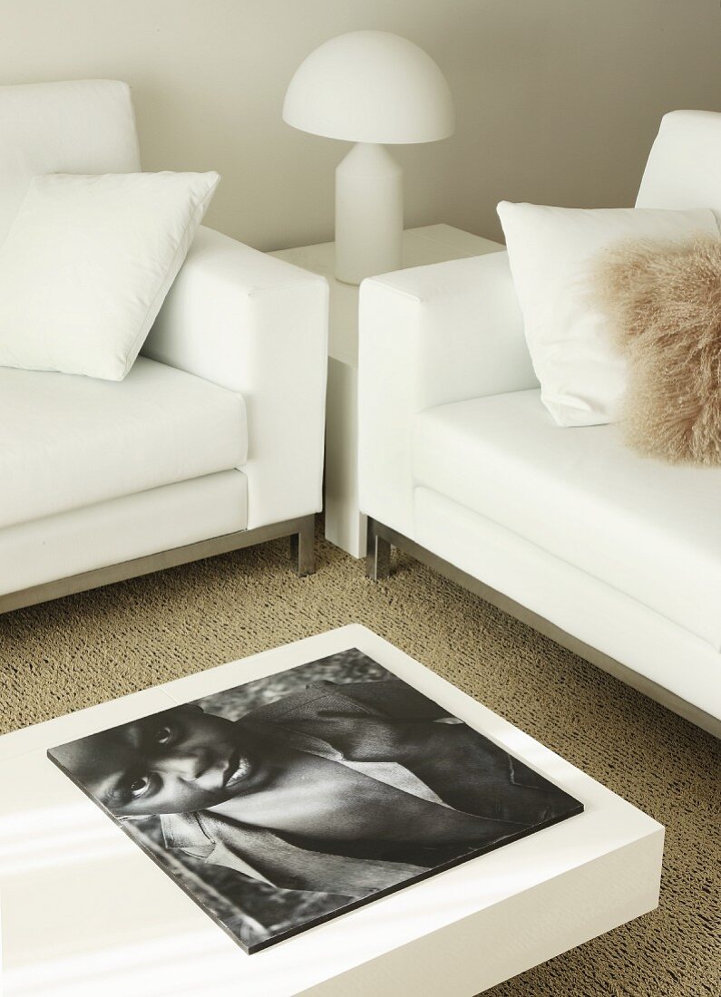 Seating area with white furniture, Italian designer lamp and coffee table