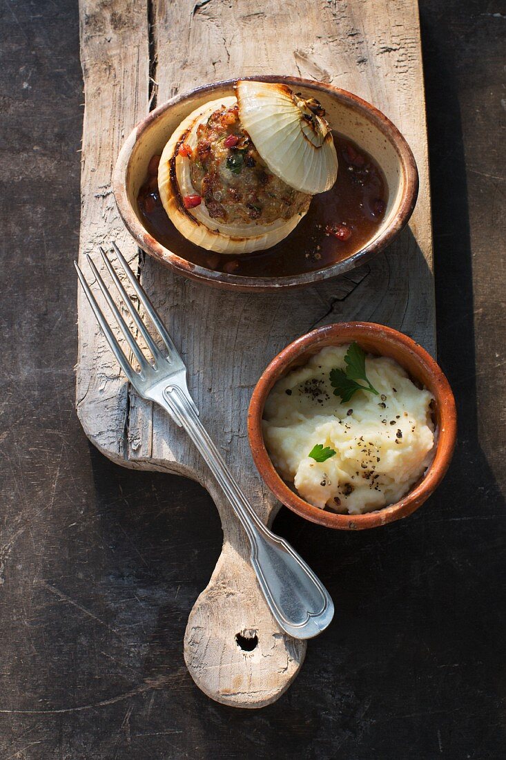 Stuffed onions in a beer sauce with mashed potatoes