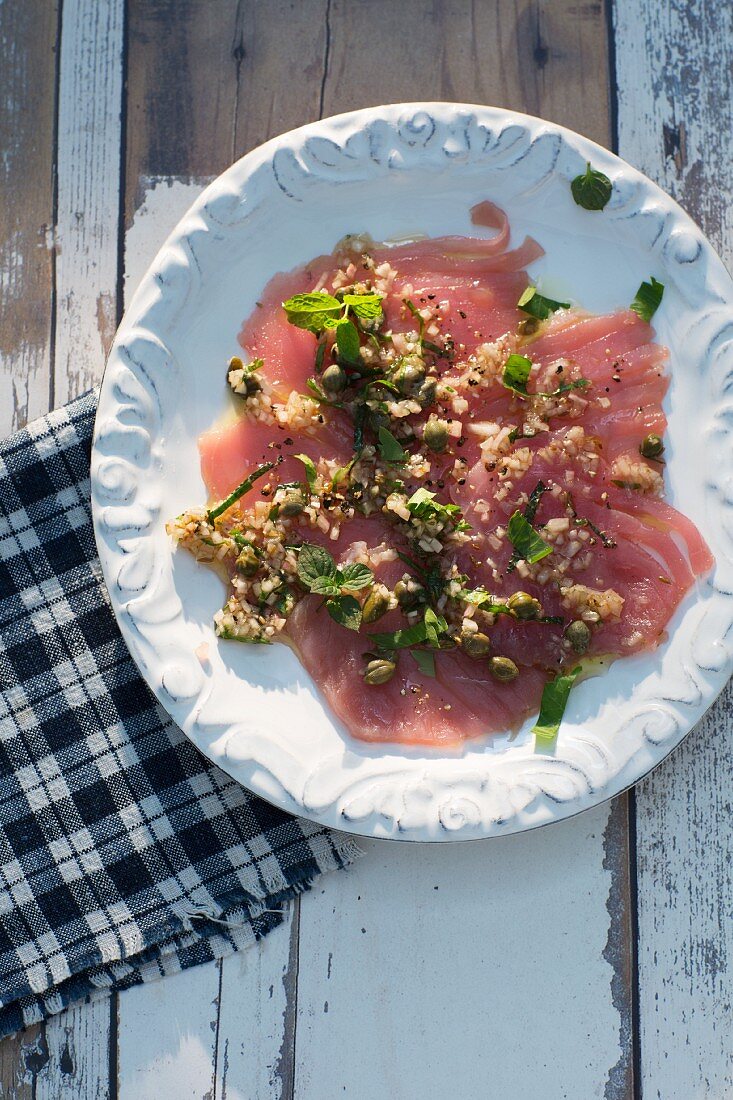 Tuna fish carpaccio with capers and mint