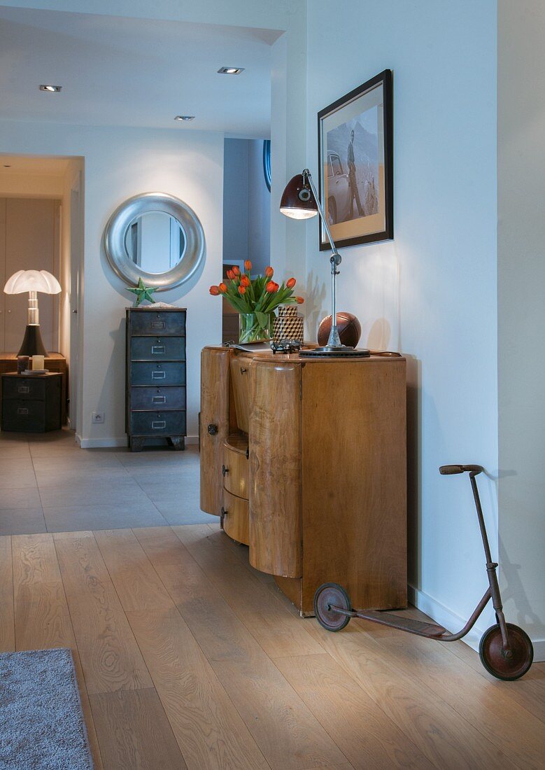 Art-Deco cabinet, filing cabinet and old child's scooter in hallway