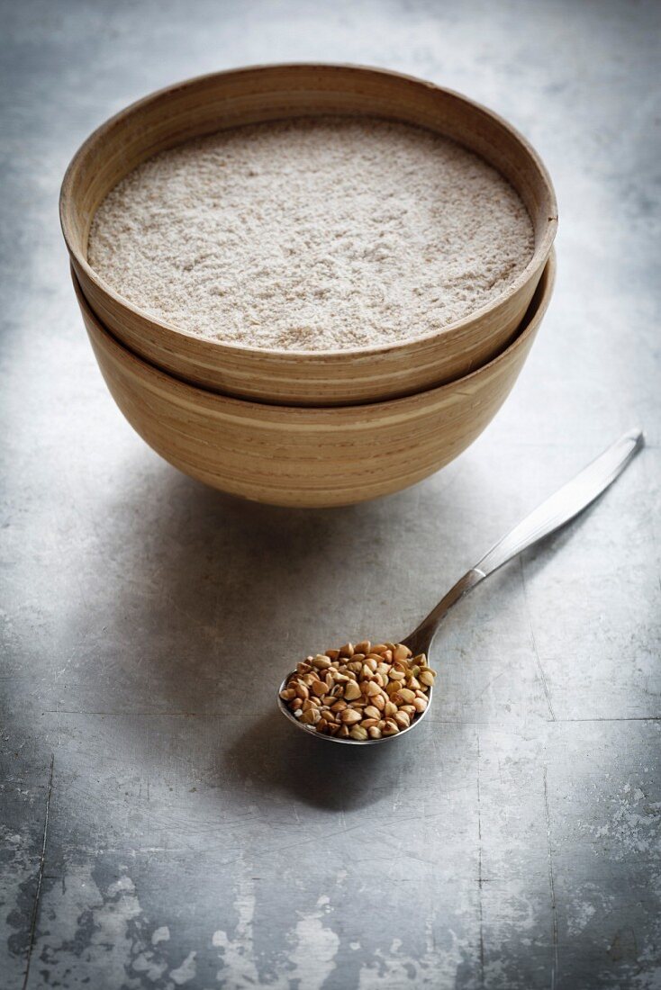 Buckwheat flour and a spoon of buckwheat grains