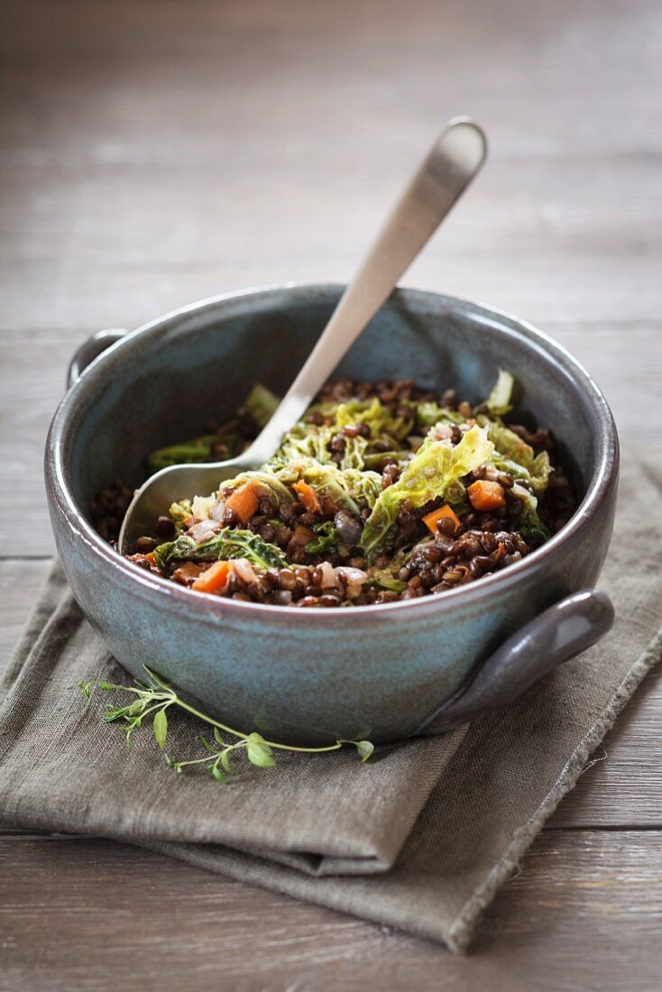 Beluga lentil stew with savoy cabbage, tomatoes and carrots