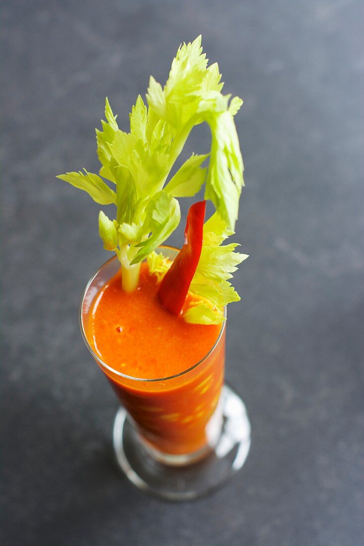 Pepper and orange gazpacho with a stick of celery and sweetcorn