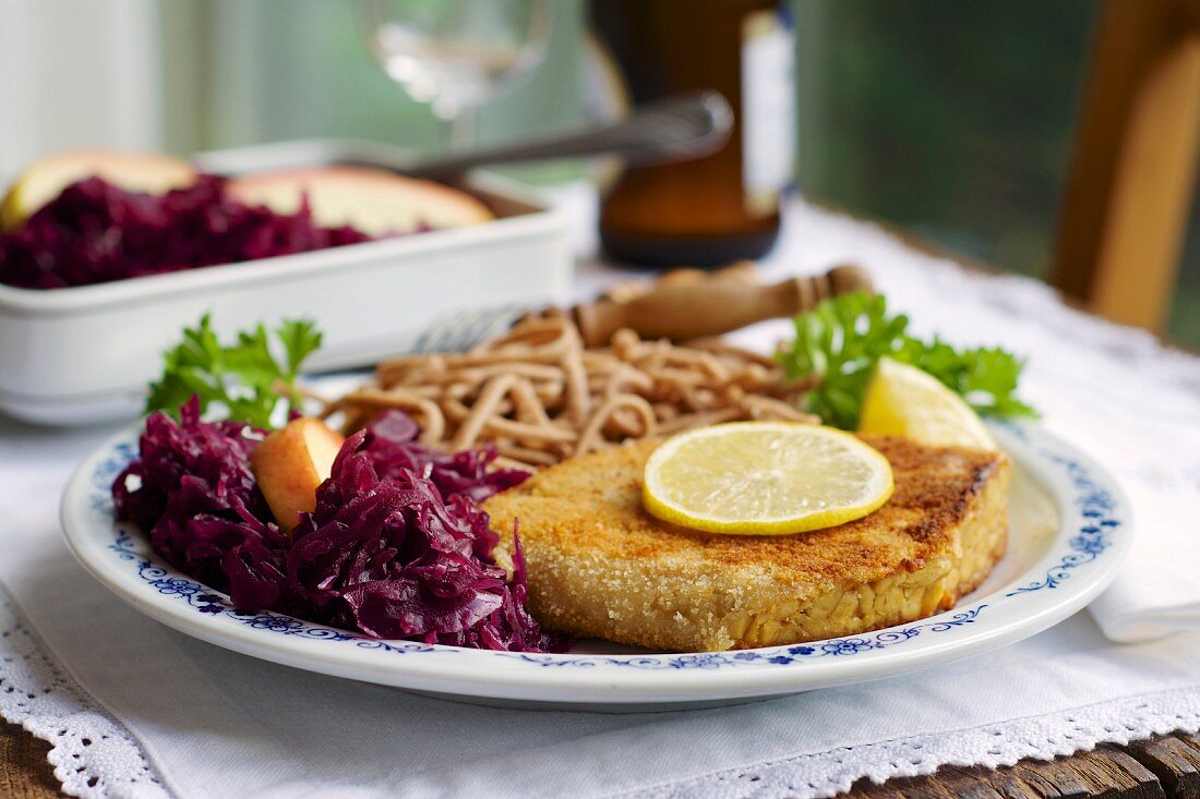 Tempeh schnitzel with red cabbage and wheat Spätzle (soft egg noodles from Swabia)