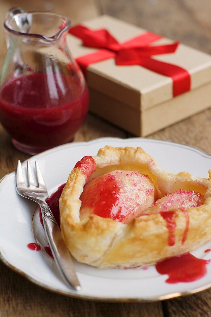 A heart-shaped pear cake with redcurrant sauce