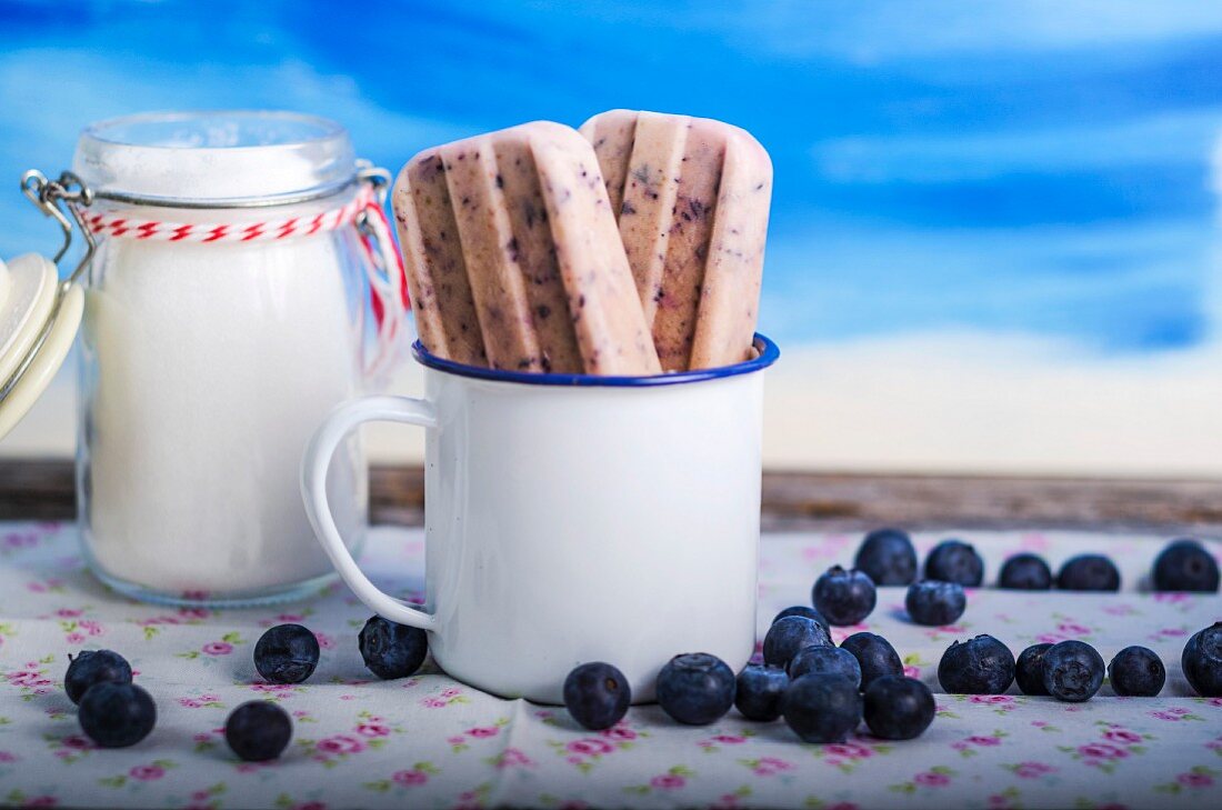 Blueberry ice cream sticks in a coffee cup