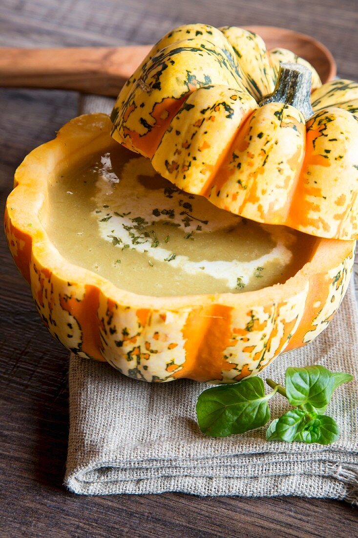 Cream of pumpkin soup in hollowed-out pumpkin