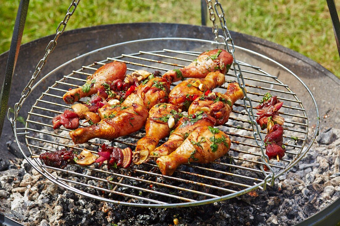 Marinated chicken legs with teriyaki sauce on a barbecue