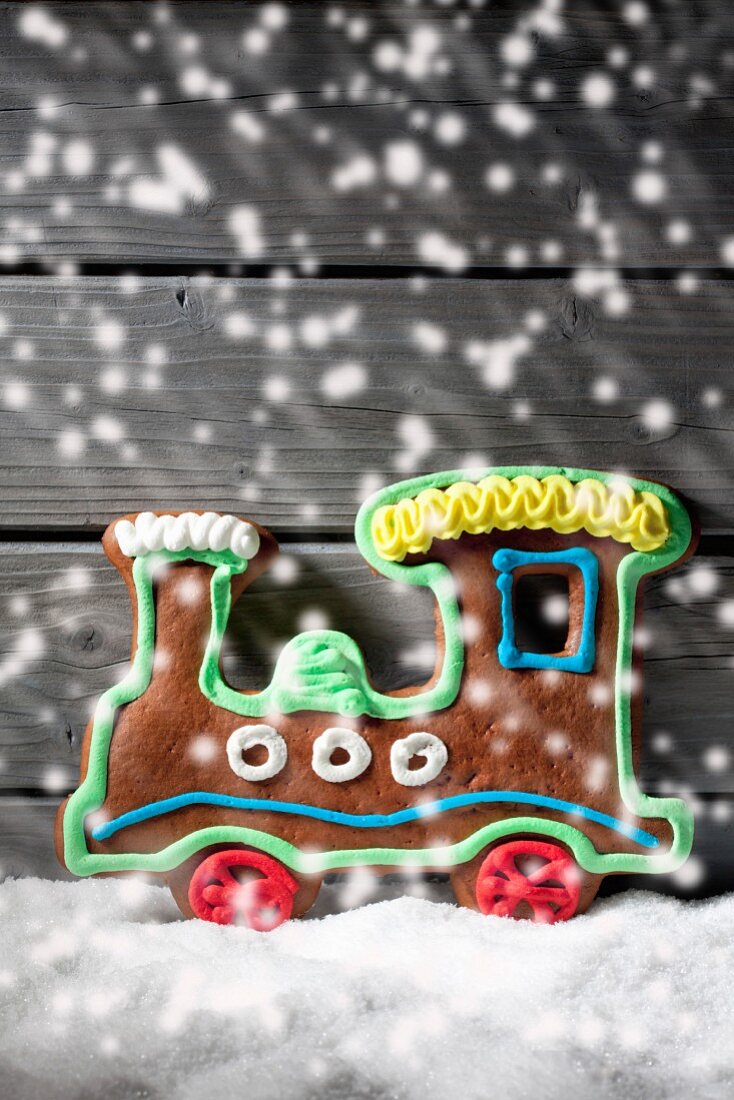 A gingerbread locomotive with falling artificial snow