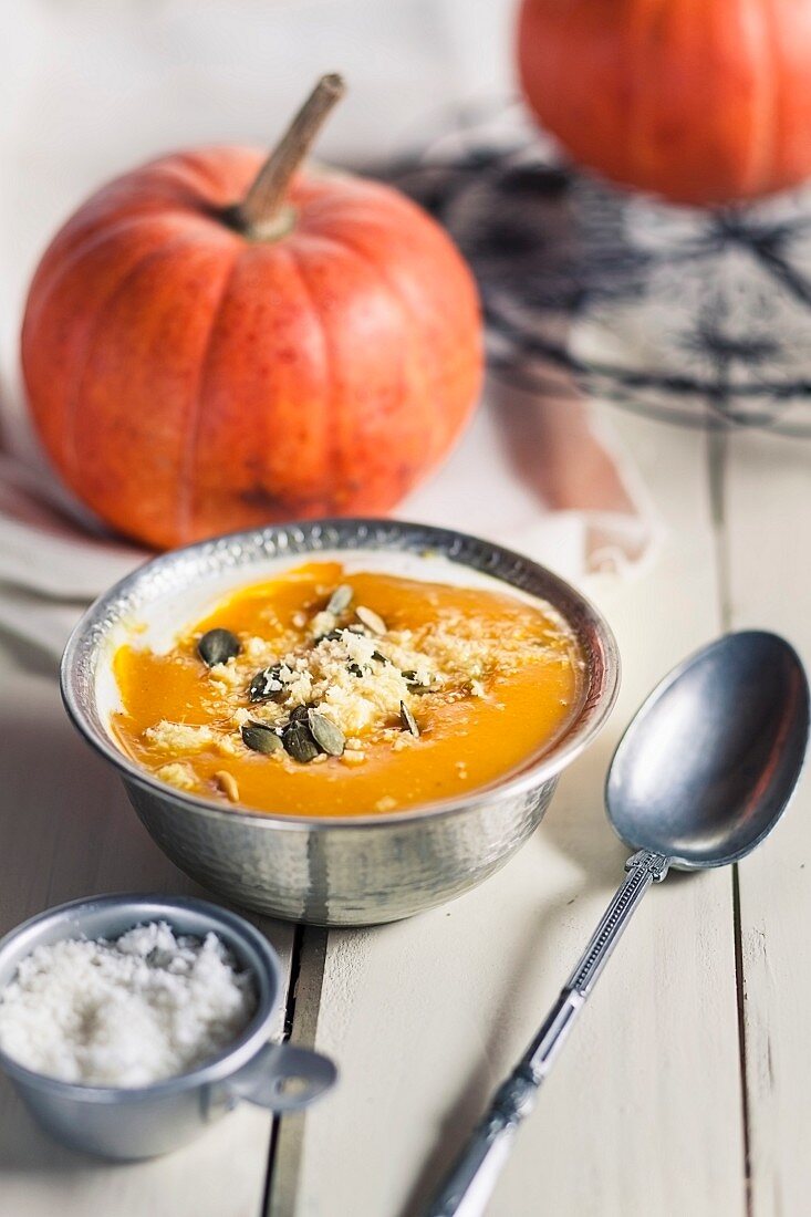 Exotic pumpkin soup with coconut milk and coconut flakes
