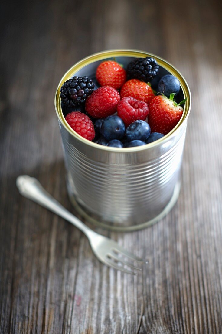 Fresh berries in a tin can
