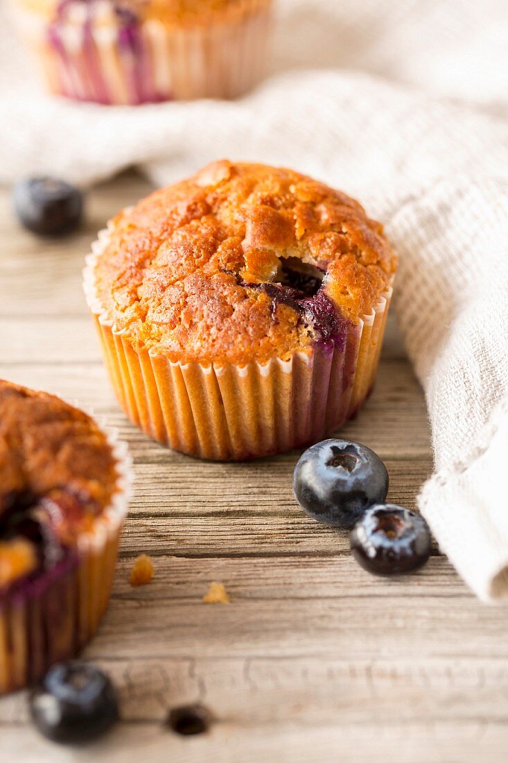 Birch sugar and blueberry muffins on a wooden surface