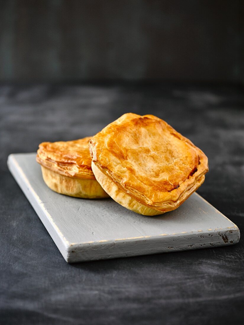 Mini meat pies on a wooden board