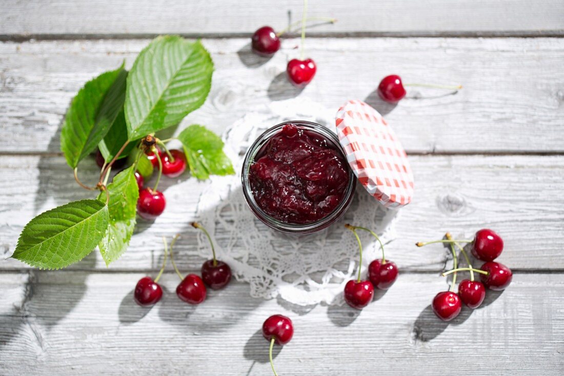 A jar of cherry jam and sour cherries