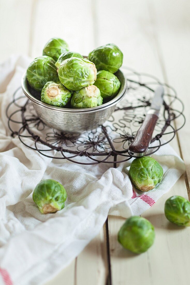 Peeled Brussels sprouts in metal bucket and next to it