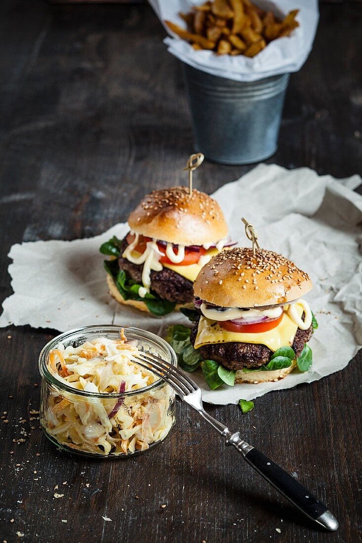 Homemade cheeseburgers with coleslaw and chips