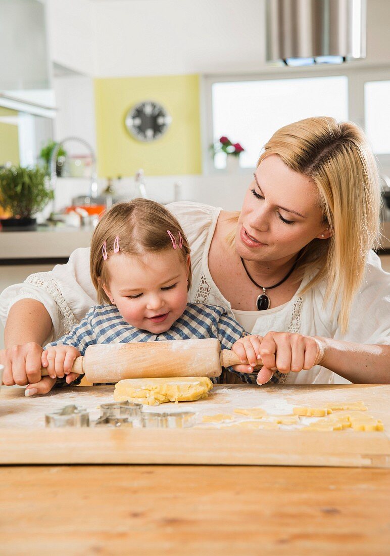 Mother and daughter with flour on nose baking in kitchen