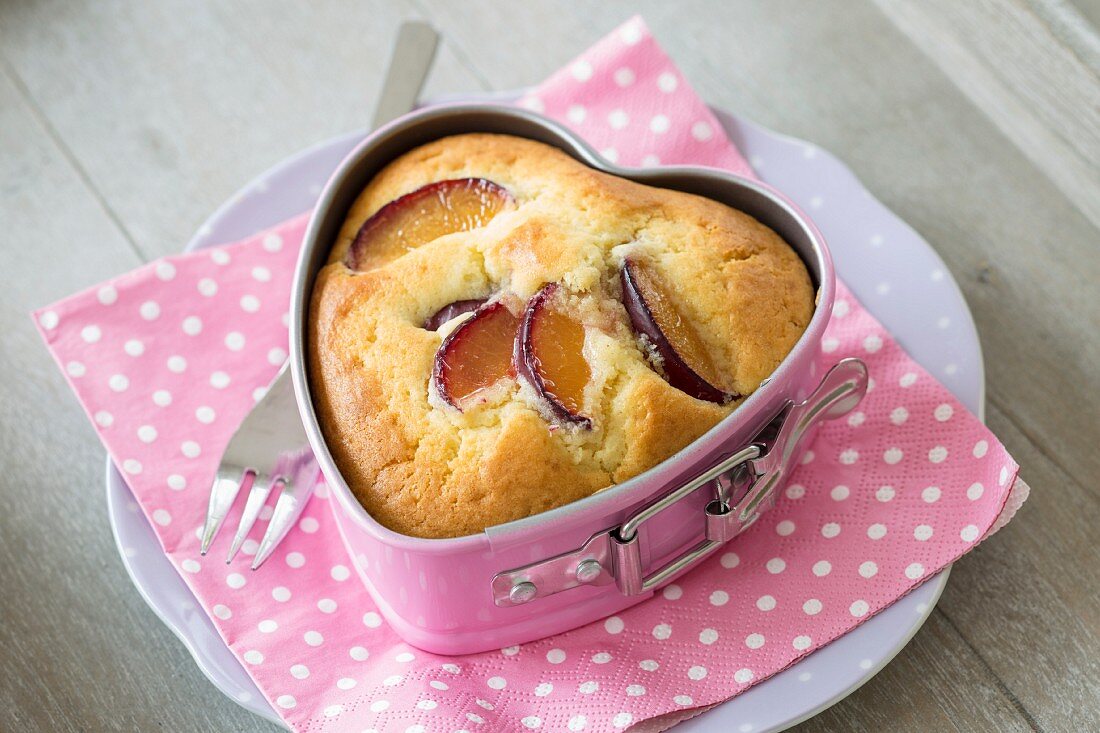 A plum cake in a heart-shaped baking tin