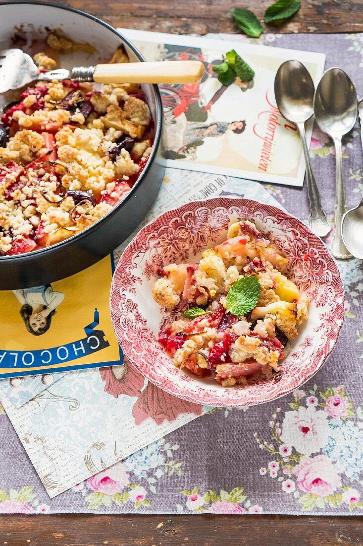 Apple and strawberry crumble on a plate and in a baking tin