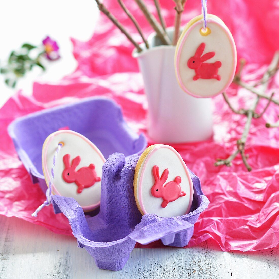 Egg-shaped Easter biscuits decorated with rabbits in an egg box