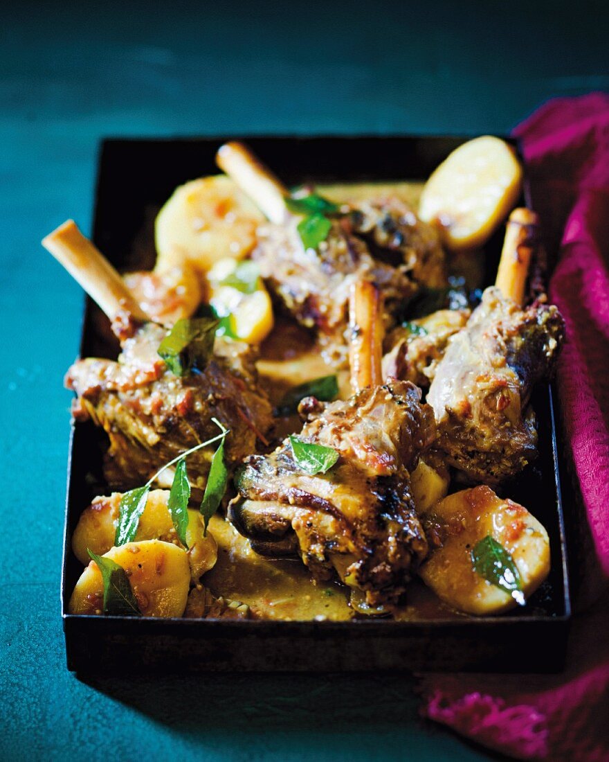 Braised lamb shanks with potatoes in a coconut sauce