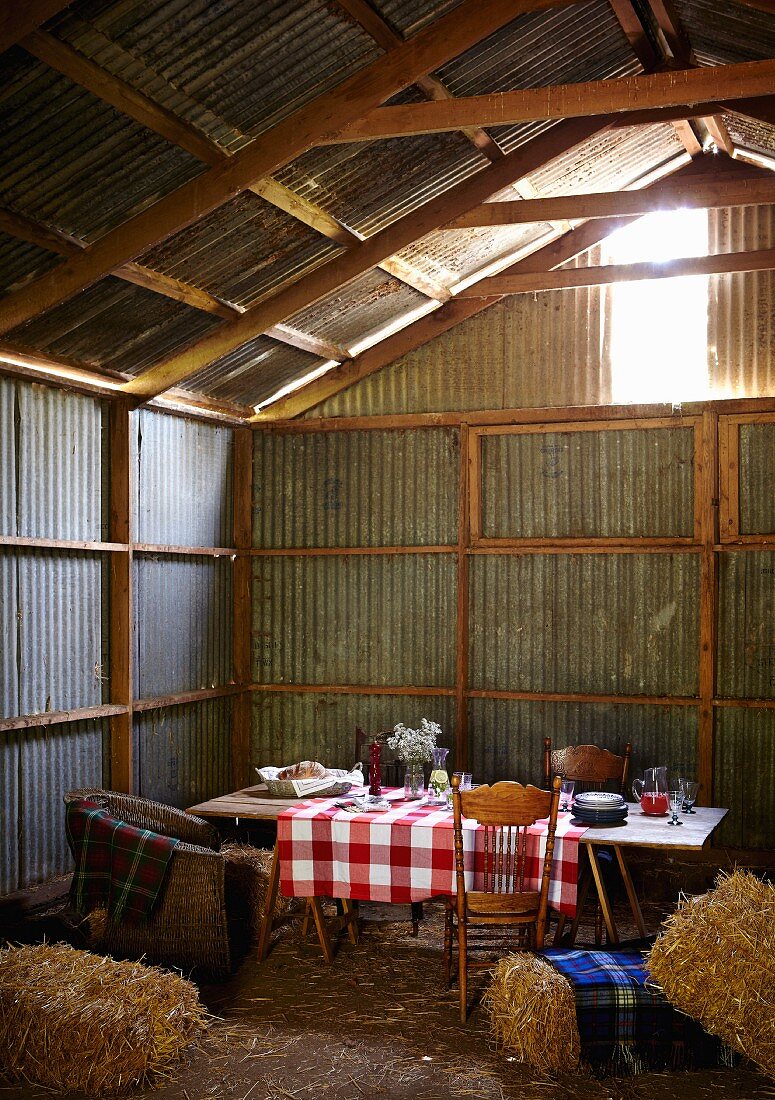 A rustic table laid in a barn