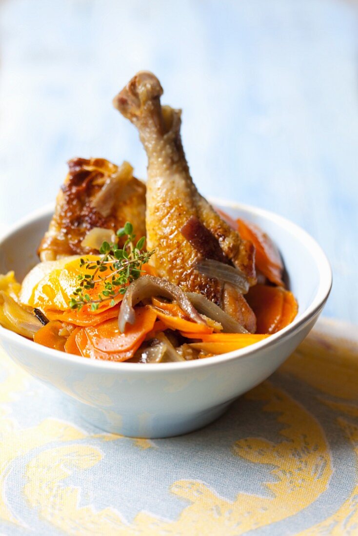 Chicken leg with carrots, onions and potatoes