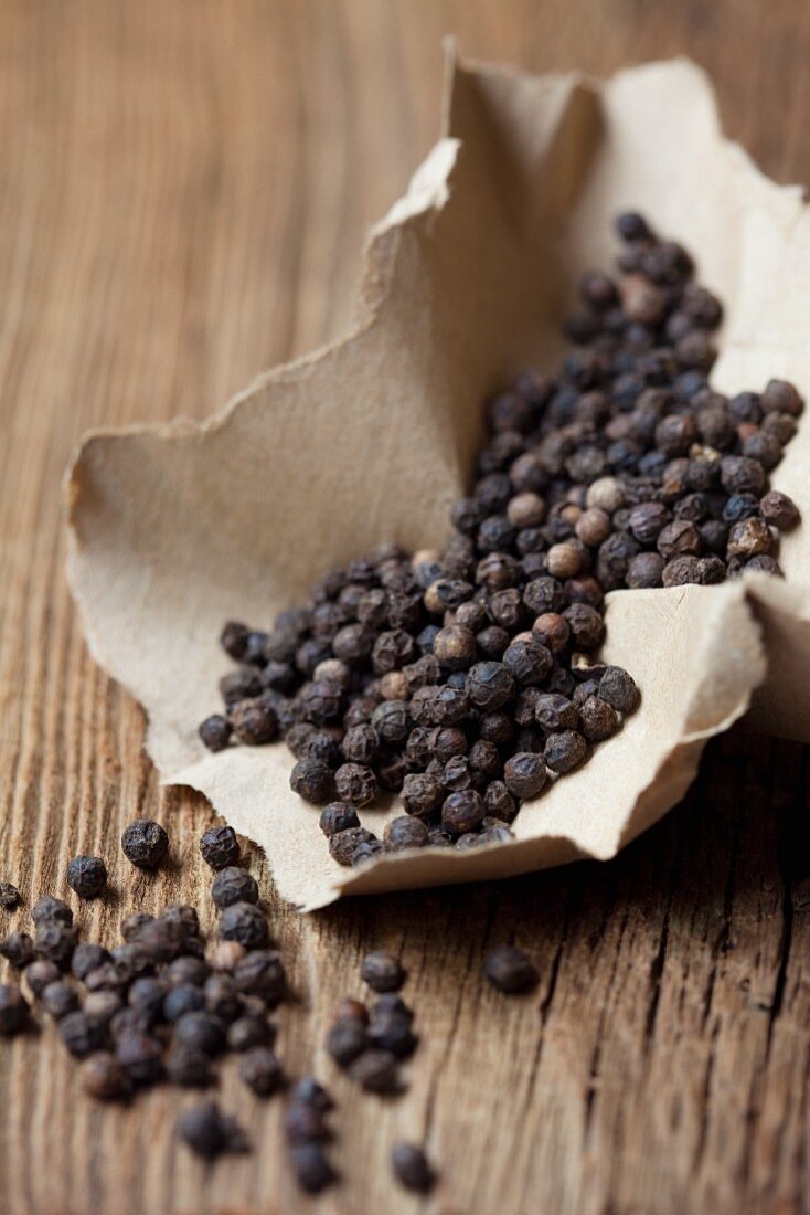 Black peppercorns on a piece of paper