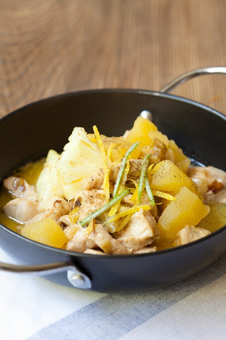 Chicken in coconut milk with lemons, apples and pineapple