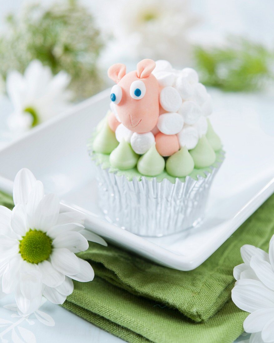 A cupcake decorated with a marshmallow fondant sheep