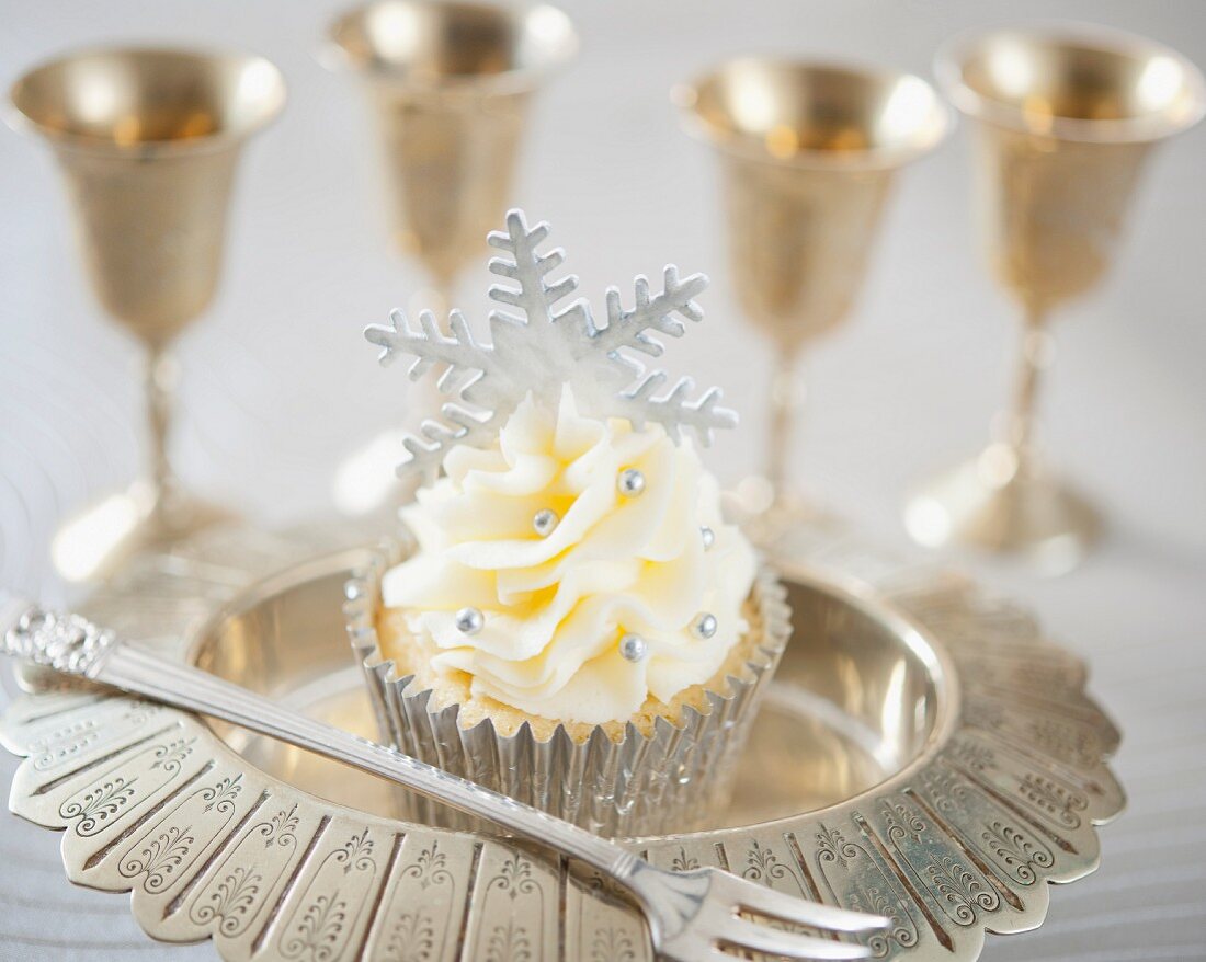 A festive Christmas cupcake with silver fondant snowflake