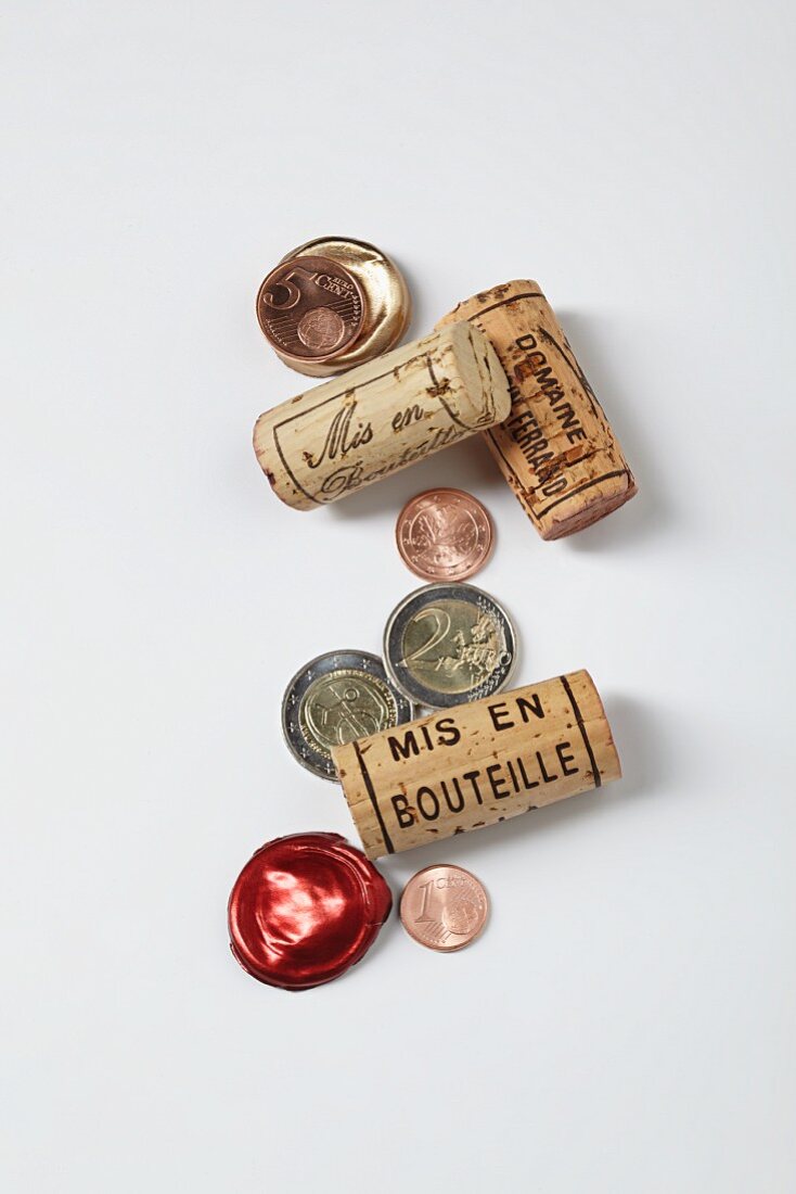 A symbolic image of a gourmet investment: wine bottle corks and money