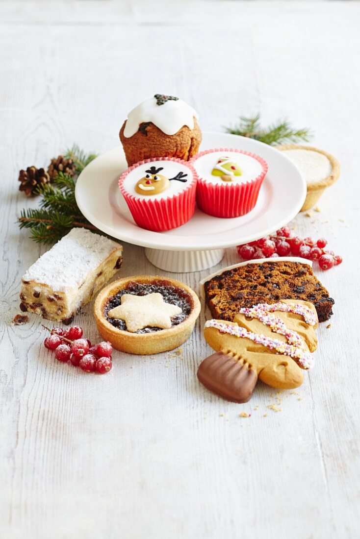 Various different Christmas cakes, mince pies, biscuits and cupcakes